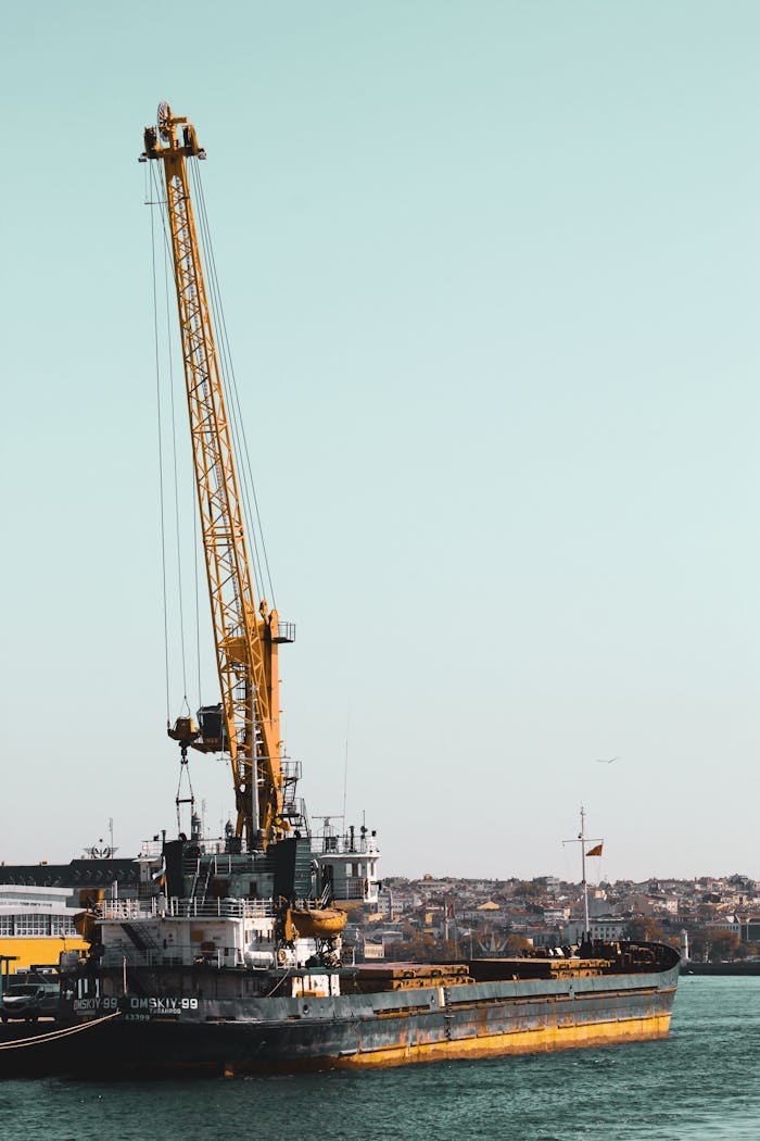 A cargo ship with a crane docked at the Istanbul port, highlighting industrial logistics.